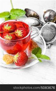 Fruit tea with strawberries. Summer fruit tea with strawberries in glass