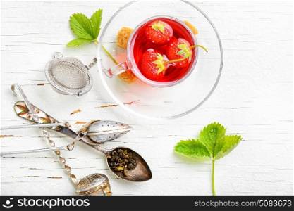 Fruit tea with strawberries. Summer fruit tea with strawberries on light background
