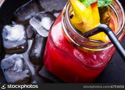 fruit tropical juice. fruit tropical cocktail with pieces of cannon in a glass beaker