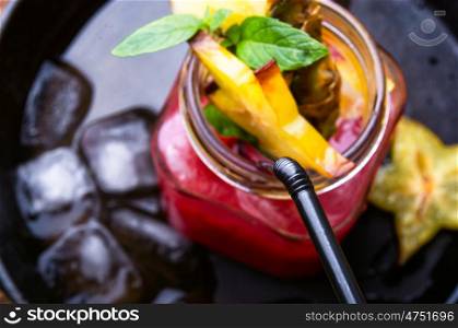 fruit tropical juice. fruit tropical cocktail with pieces of cannon in a glass beaker