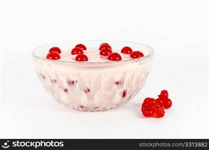 Fruit yoghurt with currants in glass bowl isolated on white