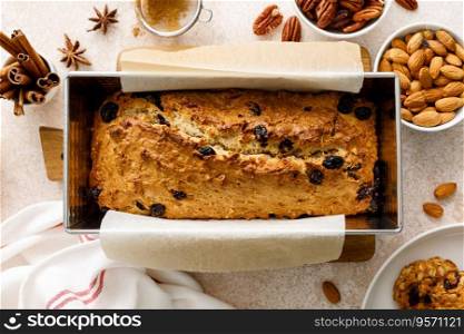 Fruitcake with cranberry, almond and pecan nuts in baking form