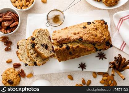 Fruitcake with cranberry, almond and pecan nuts sliced on a wooden board