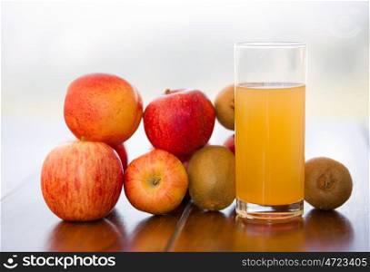 fruits and juice on a wooden table, outdoor
