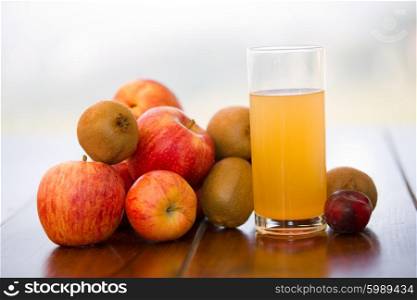 fruits and juice on a wooden table, outdoor