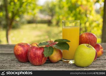 fruits and peach juice on a wooden table, outdoor