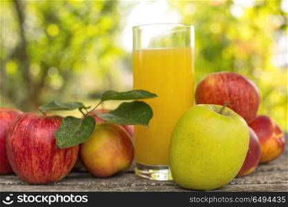 fruits and peach juice on a wooden table, outdoor. fruits and juice