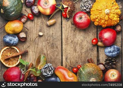 Fruits and pumpkins,nut in autumn still life on wooden table.Fall still life.Autumn background. Autumn fruit background