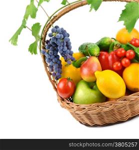 fruits and vegetables in a wicker basket isolated on white background