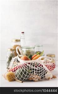 Fruits and vegetables in reusable cotton bags and glass jars with pasta, lentils, beans, rice, dry herbs. Zero waste, Recycling, Sustainable lifestyle concept
