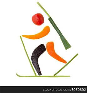 Fruits and vegetables in the shape of a biathlete skiing a final lap after a penalty loop.