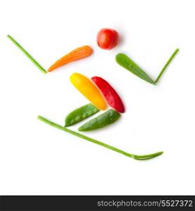 Fruits and vegetables in the shape of a slalom skier sliding downhill.