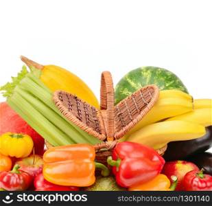 Fruits and vegetables in wicker basket isolated on white background. Free space for text.
