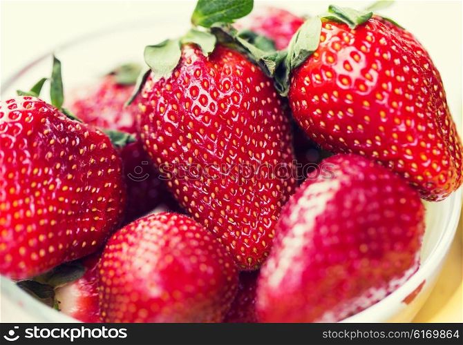 fruits, berries, diet, eco food and objects concept - close up of fresh ripe red strawberries over white