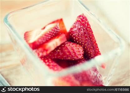 fruits, berries, diet, eco food and objects concept - juicy fresh ripe red strawberries in glass bowl
