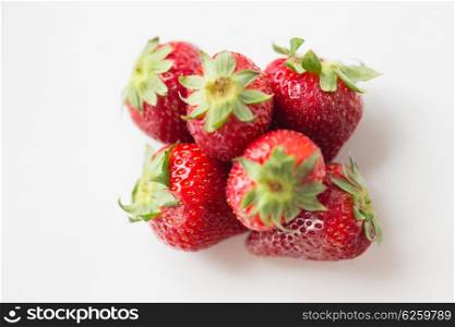 fruits, berries, diet, eco food and objects concept - juicy fresh ripe red strawberries on white