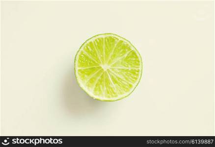 fruits, citrus, diet and objects concept - lime slice over white
