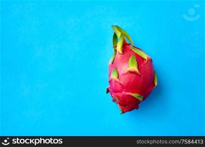 fruits, diet and food concept - ripe dragon fruit or pitaya on blue background. ripe dragon fruit or pitaya on blue background