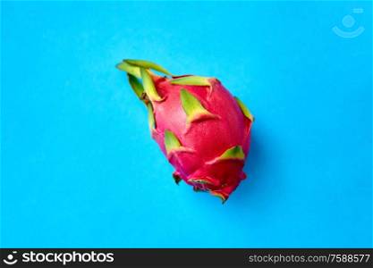 fruits, diet and food concept - ripe dragon fruit or pitaya on blue background. ripe dragon fruit or pitaya on blue background