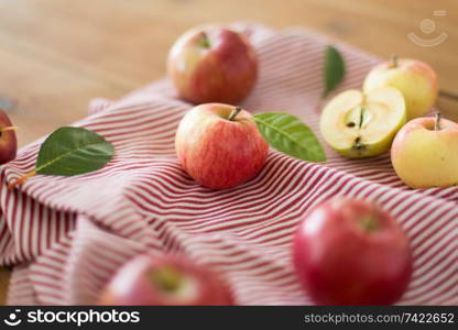 fruits, food and harvest concept - ripe red apples on wooden table. ripe red apples on wooden table