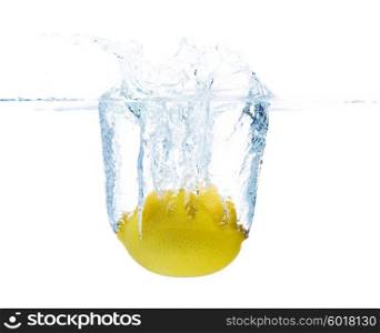 fruits, food and healthy eating concept - close up of fresh lemon falling or dipping in water with splash over white background