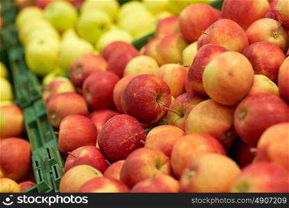 fruits, harvest, food and sale concept - ripe apples at grocery store or market. ripe apples at grocery store or market