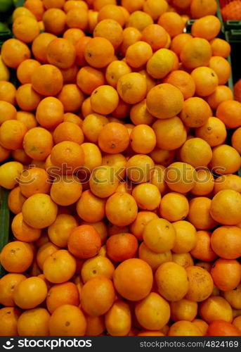 fruits, harvest, food and sale concept - ripe mandarins at grocery store or market