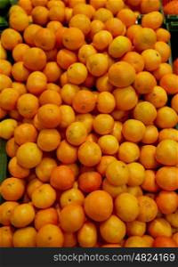 fruits, harvest, food and sale concept - ripe mandarins at grocery store or market