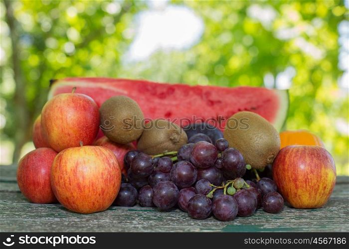 fruits in wooden table, outdoor, in the garden