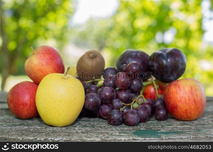 fruits in wooden table, outdoor, in the garden