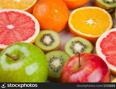 Fruits mix grapefruit orange apples and kiwi on white