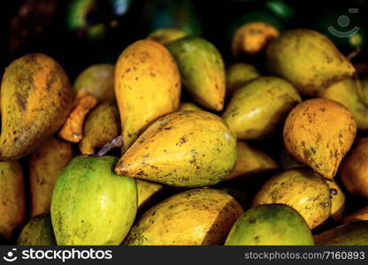 Fruits of countryside on wooden table with background.