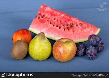 fruits on a blue wooden table, studio picture