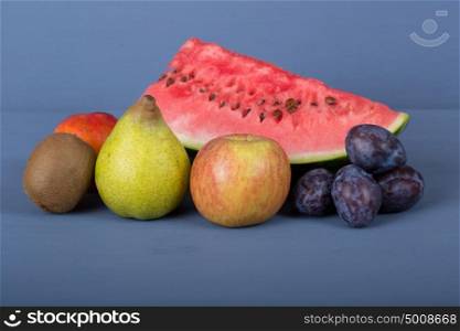 fruits on a blue wooden table, studio picture