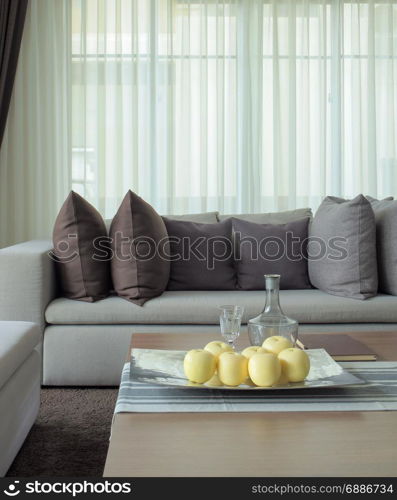 Fruits on tray with beige sofa in the living room