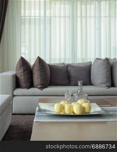 Fruits on tray with beige sofa in the living room