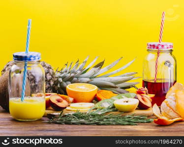 fruits rosemary juice mason jar chopping board against yellow backdrop. High resolution photo. fruits rosemary juice mason jar chopping board against yellow backdrop. High quality photo