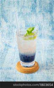 Fruity Bubble Tea in glass cup on blue background. Fruity Bubble Tea in glass cup on blue background