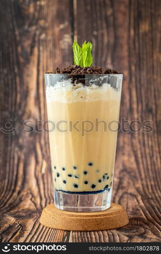 Fruity Bubble Tea in glass cup on wooden background