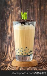 Fruity Bubble Tea in glass cup on wooden background