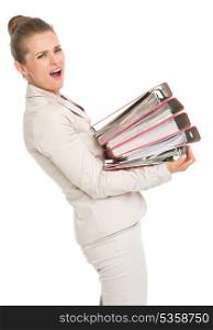 Frustrated business woman holding stack of folders