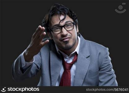 Frustrated businessman gesturing over black background