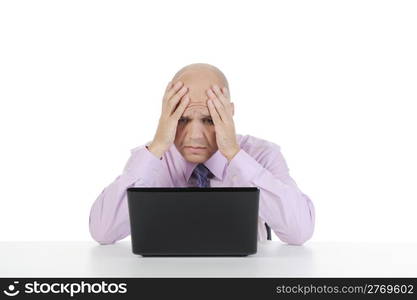 Frustrated businessman in front of laptop. Isolated on white background