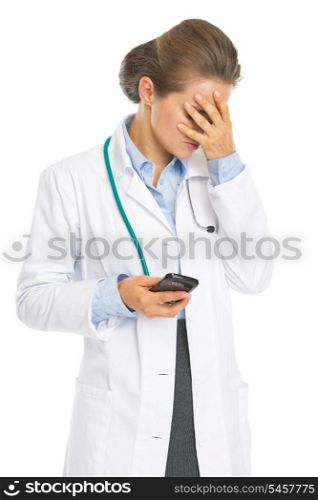 Frustrated doctor woman with cell phone