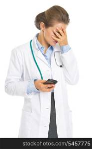 Frustrated doctor woman with cell phone