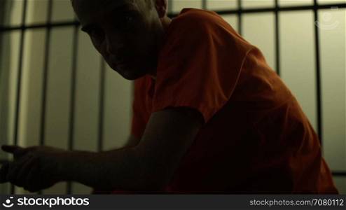 Frustrated Inmate stares at camera in a jail or prison