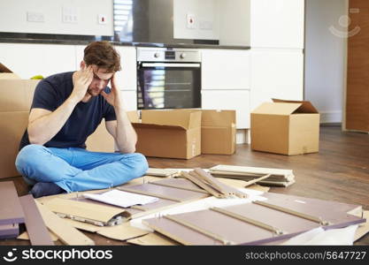 Frustrated Man Putting Together Self Assembly Furniture