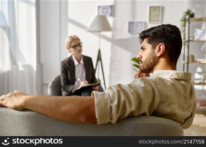 Frustrated pensive sad man at psychotherapist individual therapy session. Psychological consultation. Frustrated pensive sad man at psychotherapist consultation