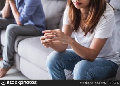 Frustrated sad wife taking off the wedding ring, Young couple breaking up divorce concept