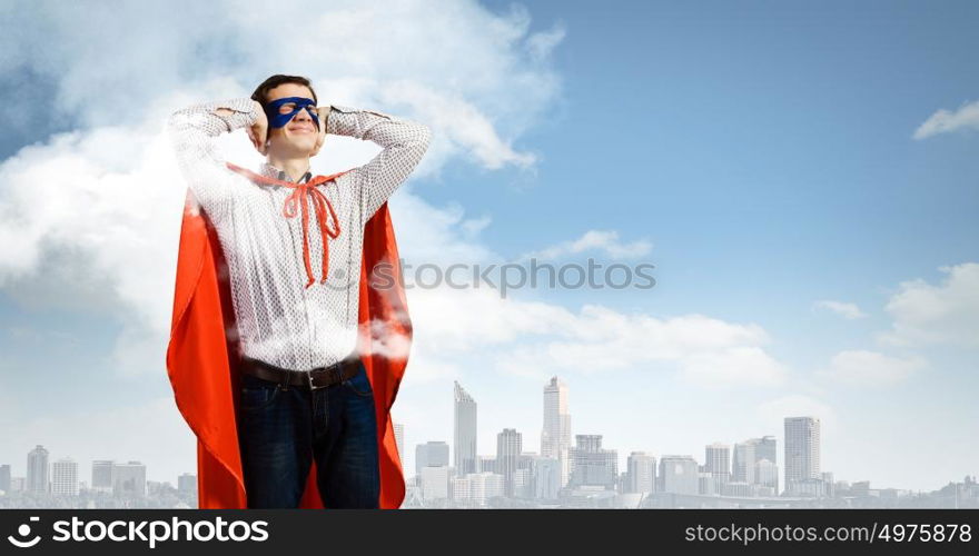 Frustrated superman. Young man in hero costume closing ears with palms